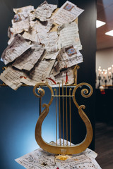 Halloween decoration. A stringed lyre musical instrument and notes in blood