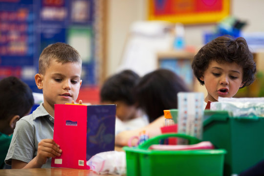 Students reading in a kindergarten classroom. 