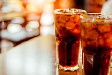 Two glass soft drink with ice in restaurant background