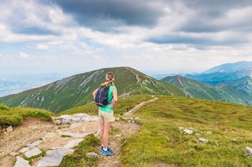 Woman walking on mountain trail