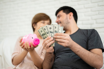 Happy Young couple counting money.