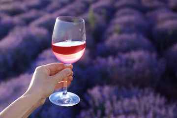 Woman with glass of wine in lavender field