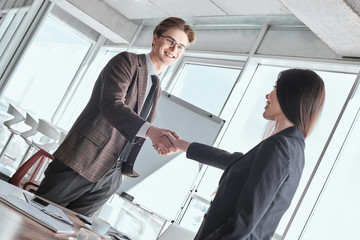 Businesspeople at office working together shaking hands happy de