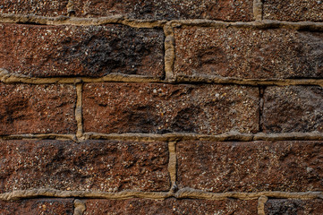 Red brick dirty textured background with a cement in a seams