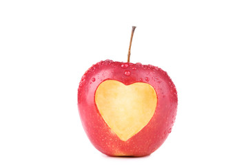 Plakat Red apple with cutout heart shape on white background