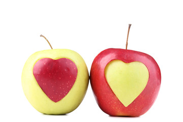 Plakat Green and red apple with cutout heart shape on white background