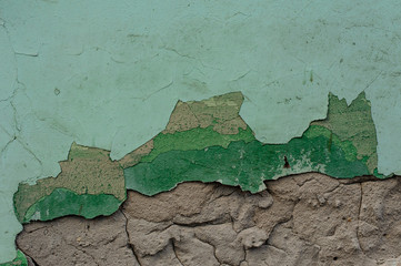Background texture of the green painted cracked wall