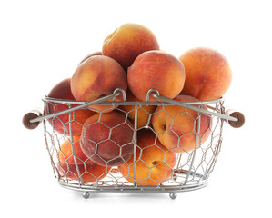 Metal basket with fresh sweet peaches on white background