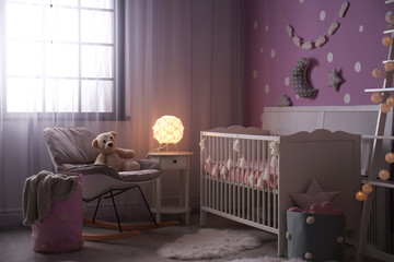 Baby room interior with crib near color wall