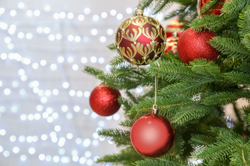 Obraz na płótnie Canvas Christmas tree with festive decor against blurred fairy lights