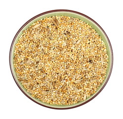Mixed bird seed, millet pile in porcelain bowl isolated on white background, top view