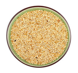 Millet pile in porcelain bowl isolated on white background, top view