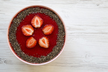Top view bowl of strawberry smoothie with chia seeds. From above. Copy space and text area.