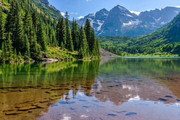 Maroon Lake - A Spring evening at colorful Maroon Lake, with Maroon Bells rising in the background,...