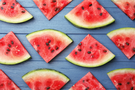 Flat lay composition with watermelon slices on wooden background