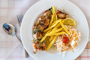 Greek meal pork souvlaki plate on a table in a Mediterranean Restaurant