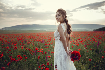 beauty woman in poppy field in white dress