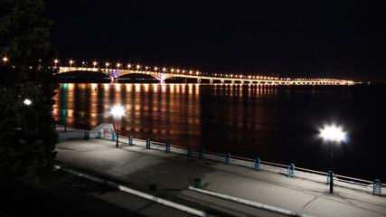 Song exposure shot of the brigde above Volga river with beautyfull lights reflected at water