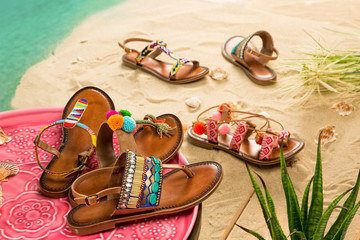 Colorful Sandals with Sand Beach Background