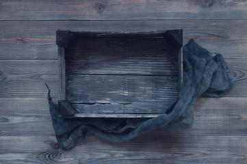 Black wooden textured background with old wooden box and cloth