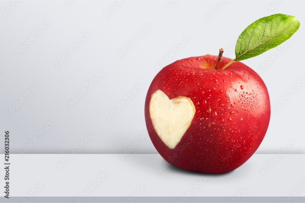 Wall mural Red apple with a heart shaped