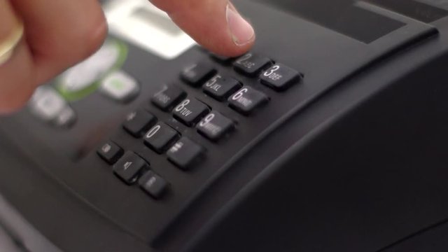 The man is calling, dials the number.