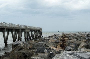 Fototapeta na wymiar The fishing pier that parallels the jetty in Cocoa Beach, Florida. 