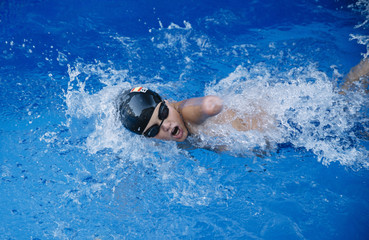 Young boy who does swimming and he lacks an arm, disabled person