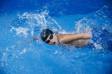 Young boy who does swimming and he lacks an arm, disabled person