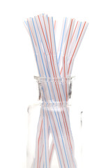 Bunch of Straws in a Glass Container on a White Background