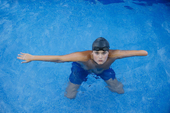Young boy who does swimming and he lacks an arm, disabled person