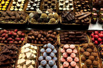 Famous sweet candy market .Confectionery at Boqueria market place in Barcelona, Spain. Assorted chocolate candy shop.
