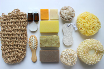 Spa accessories-sponge, natural soap, essential oil, pumice, salt, washcloth, comb, candles on a light background, top view. The concept of a healthy lifestyle. Beauty, skin care. flat position
