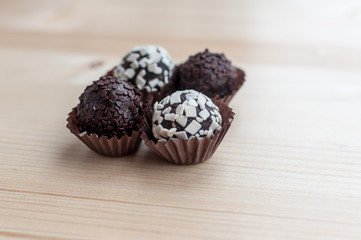 Mini cupcake desserts on a wooden table. White and dark chocolate chips