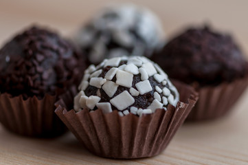 Mini cupcake desserts on a wooden table. White and dark chocolate chips