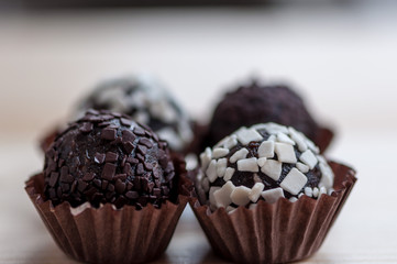 Mini cupcake desserts on a wooden table. White and dark chocolate chips