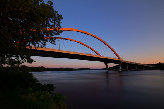 Fototapeta Hastings bridge spanning over the Mississippi River at dawn with the morning sunrise 