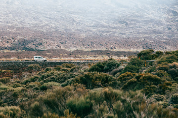 Driving car in the desert, volcanic landscape of Mt. Teide National Park, Tenerife, Canary islands