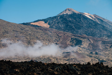 Highest point of Spain with volcano lava leftovers and mist , Mount Teide, Tenerife