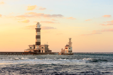 Fototapeta na wymiar Sunset on the lighthouse. Daedalus reef.