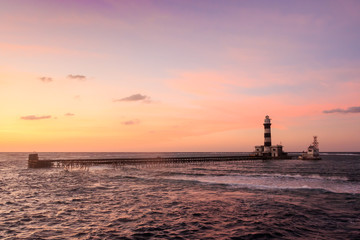 Naklejka na ściany i meble Sunset on the lighthouse. Daedalus reef.