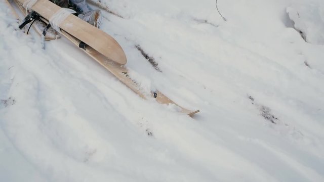 Skier after accident waiting for rescue lying in snow. Clip. Professional skier after crash accident on skiing resort slope - Winter sport emergency concept. Ski patrol team rescue injured skier with