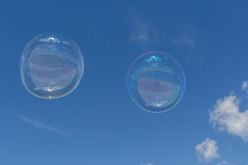 Soap bubbles, Blowing soap bubble on Blue sky background