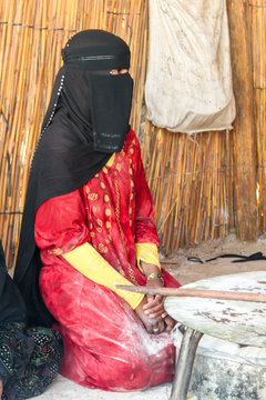 A young girl in a Bedouin village bakes bread. Egypt. South Sinai.