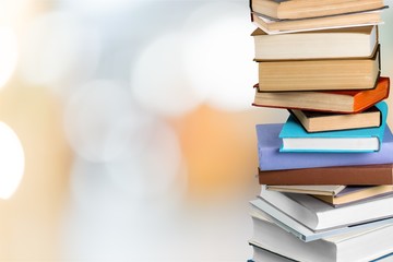 Books collection in pile on background.