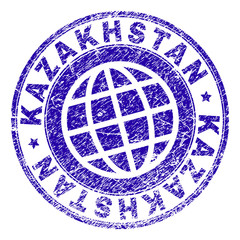 KAZAKHSTAN stamp print with grunge texture. Blue vector rubber seal imprint of KAZAKHSTAN label with grunge texture. Seal has words arranged by circle and planet symbol.