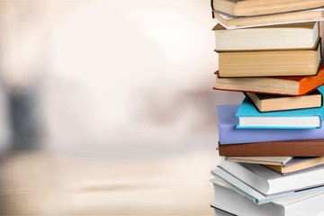Books collection in pile on background.