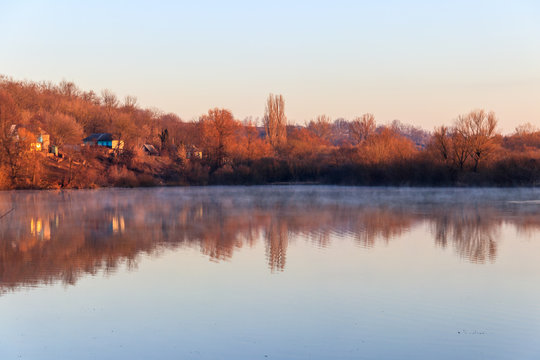 View on the peaceful lake and village at morning