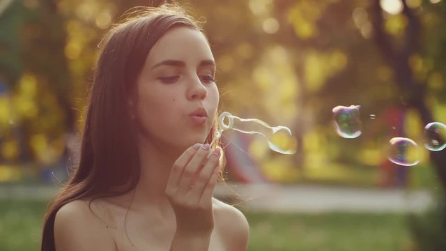 Teenage girl blowing bubbles