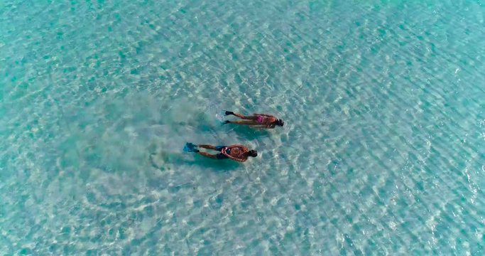 a couple doing snorkeling in a lagoon in French Polynesia